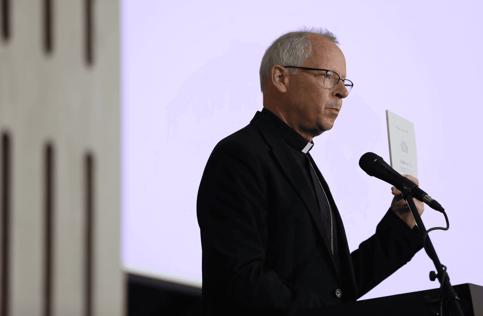Archbishop Bert van Megen holding a copy of Dilexi Te at the Africa Digital Assets Summit